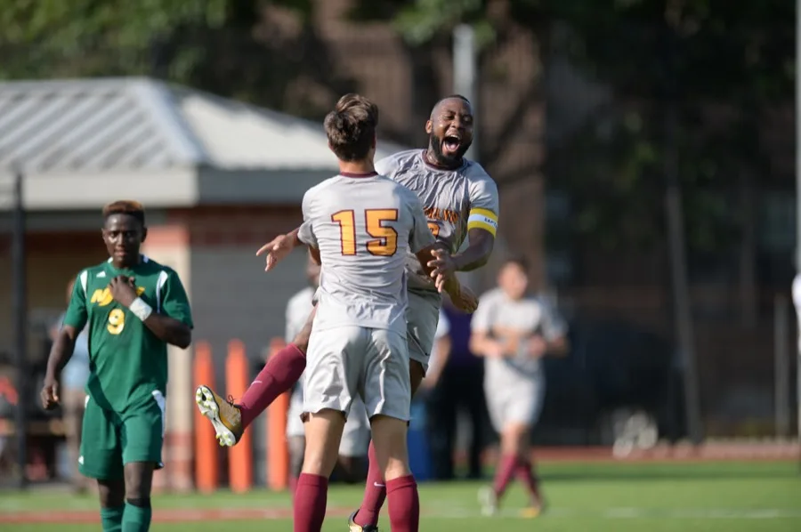 Jean-Luc celebrating a goal with a teammate at Brooklyn College